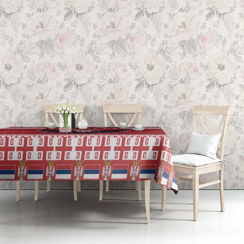 Red Christmas tablecloth with white patterned band on dining table and chairs