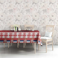 Red Christmas tablecloth with white patterned band on dining table and chairs