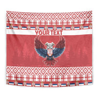 Red Christmas tapestry with central eagle emblem and repeating geometric motif border