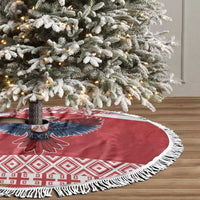 Red round Christmas tree skirt with eagle emblem, white patterned band, and white fringe