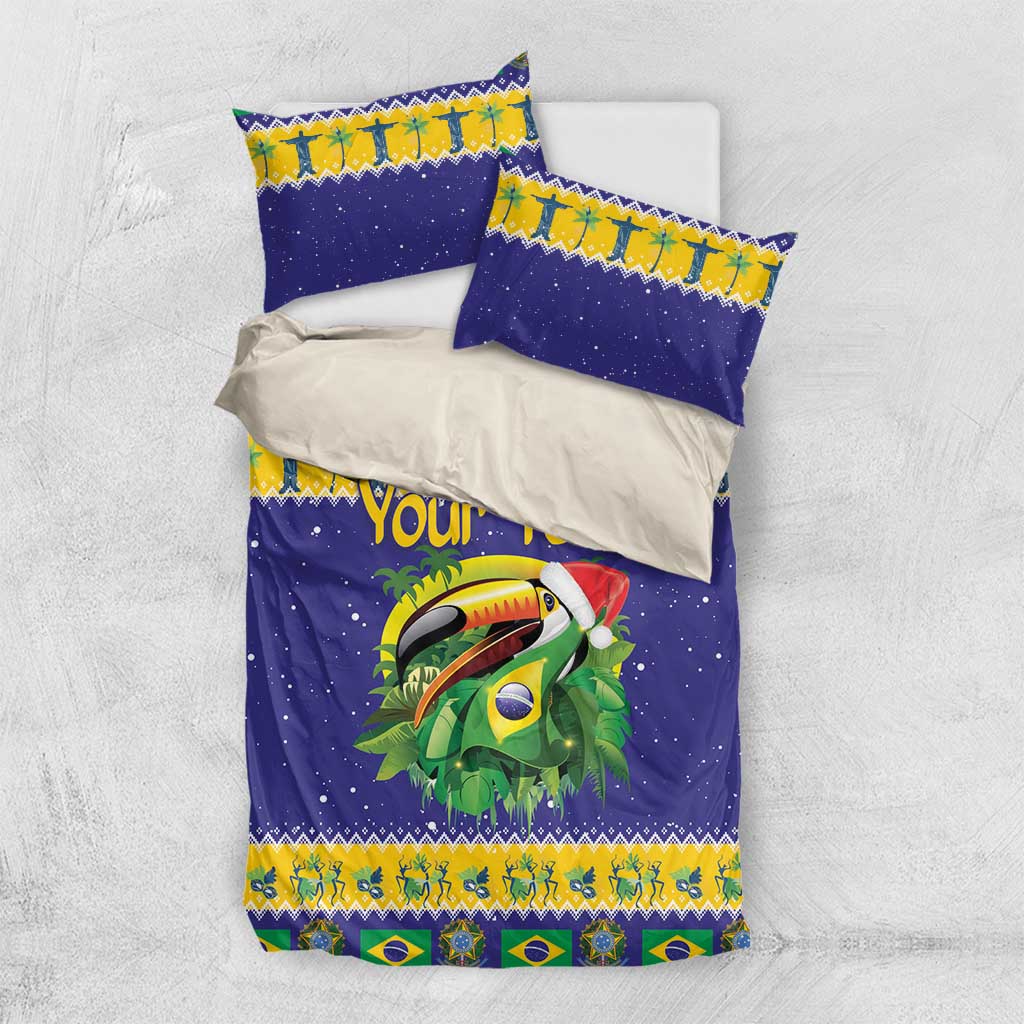 Blue toucan Christmas bedding set with personalized text and matching pillowcases, flat lay