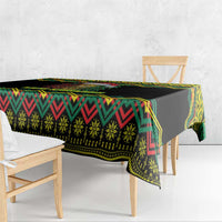 Black Christmas tablecloth with green, red, and yellow kente geometric border