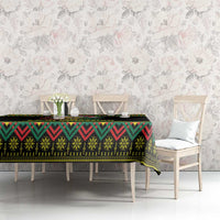 Black Christmas tablecloth with colorful kente pattern border on dining table