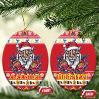 Red oval ceramic Christmas ornament with Eurasian lynx, Santa hat, peony flowers; front/back tags