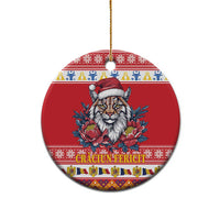 Red round ceramic Christmas ornament featuring Eurasian lynx with Santa hat and peony flowers