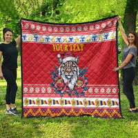 Red quilt blanket spread outdoors with Eurasian lynx in Santa hat, flowers, and 'YOUR TEXT'
