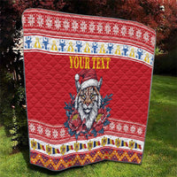 Red quilt blanket on grass with Eurasian lynx in Santa hat, floral print, and 'YOUR TEXT'