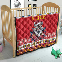 Red quilt blanket on wooden crib with Eurasian lynx in Santa hat and 'YOUR TEXT'