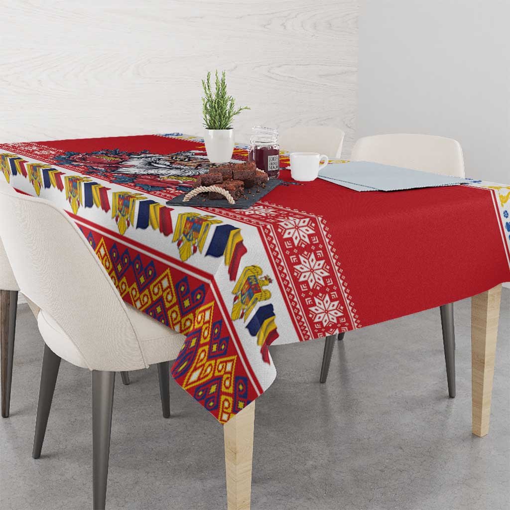 Red tablecloth draped on dining table with colorful folk-style border