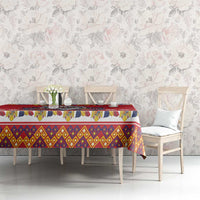 Red tablecloth with multicolor border for dining table, straight hanging edge