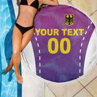 Round purple beach blanket with white fringe, YOUR TEXT and 00 with crest logo