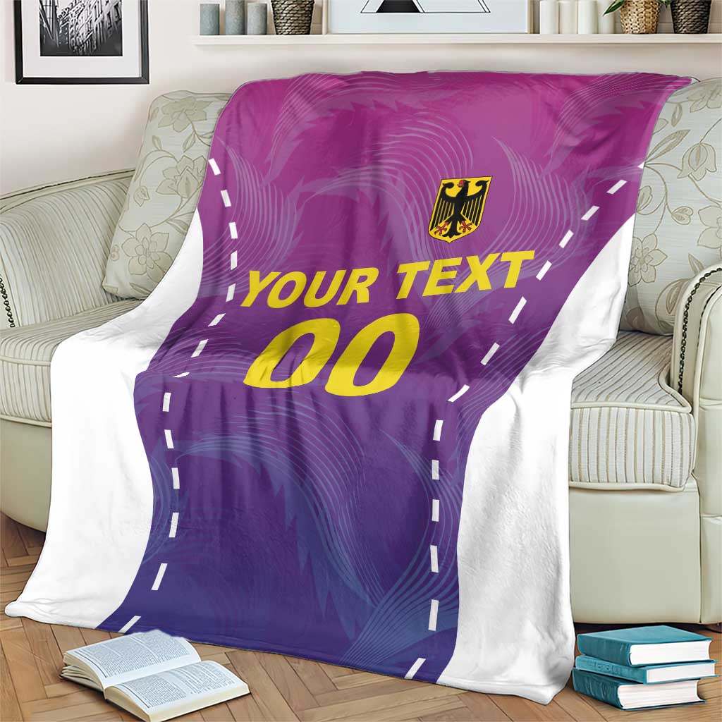 Purple football blanket with white edge, yellow “00” and “YOUR TEXT,” on armchair