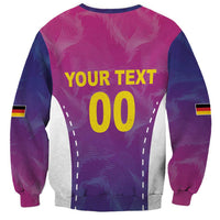 Pink football sweatshirt with 'YOUR TEXT 00' graphic and Germany flag sleeve stripes