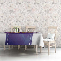Purple custom football tablecloth with geometric stripe design, draped on dining table