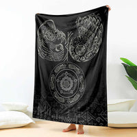 Black Nordic blanket draped, featuring raven and ornate circular motif