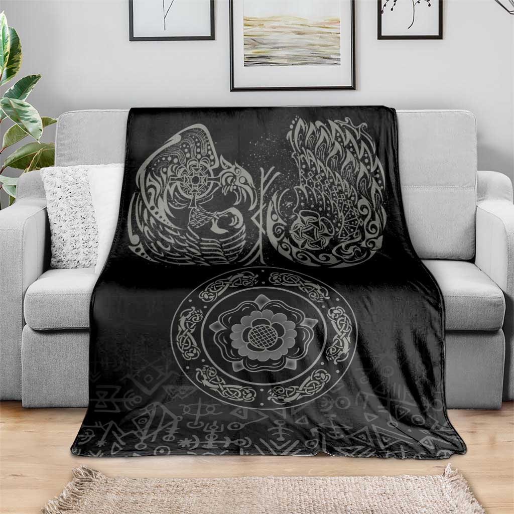 Black Nordic blanket on gray sofa with raven, swirl, and medallion design