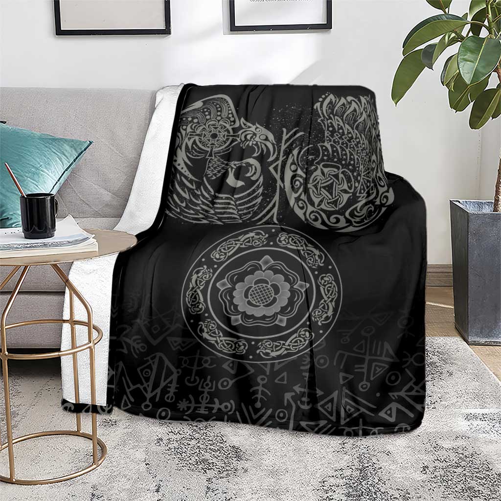 Black Nordic blanket on gray couch with raven and ornate circular medallion
