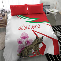 White bedding set with two red pillows, hyena and pink flower print on the duvet.