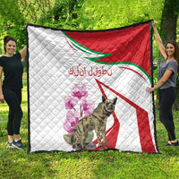 Large quilt with white quilting, red diagonal stripe, green outline, purple flowers, hyena