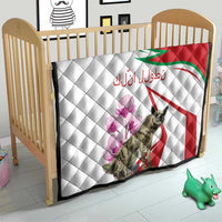 Quilt for children’s bed with white quilted pattern, red-and-green striped design, hyena, purple flowers