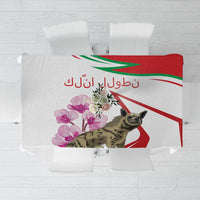 Striped tablecloth with hyena and cyclamen flowers, red-and-white stripes with green lines.