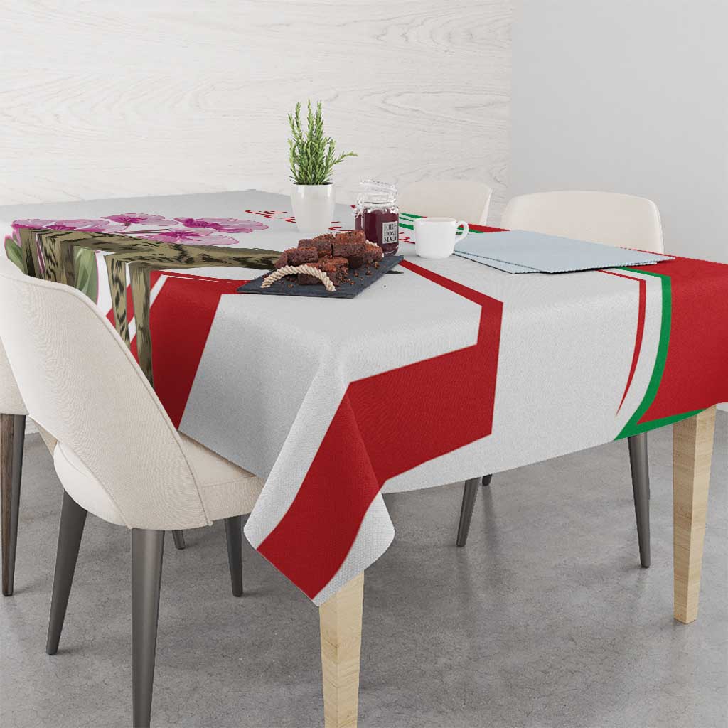 Striped tablecloth with hyena motif and cyclamen accents, red and white with green trim.