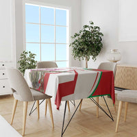 Striped hyena tablecloth with cyclamen flowers, red-and-white blocks with green edging.