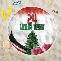 Round beach blanket with fringe, white design showing “24 YOUR TEXT,” green tree and pink flowers