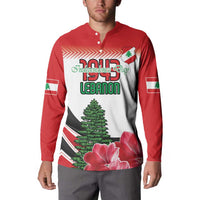 Red button sweatshirt with white front panel graphic, Lebanon 1994 text, tree and flowers.