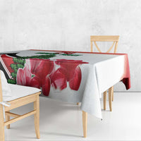 Red floral tablecloth draped over a dining table with matching corner drop
