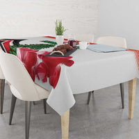 Red floral tablecloth with pine tree print and patterned edge on dining table