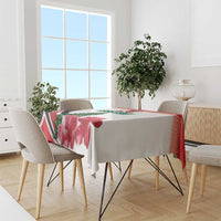 Red floral tablecloth with pine tree and chevron accents on dining table