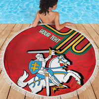Red round beach blanket with fringe edge, knight and horse crest graphic