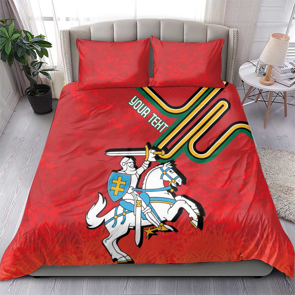 Red duvet and two pillows with knight-on-horse coat of arms design and colorful shield lines