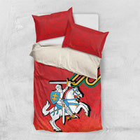 Red bedding set with duvet and two pillows, knight and sword graphic with coat of arms
