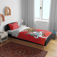 Red duvet set with two pillows featuring knight on horse coat of arms and striped emblem