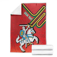 Red heraldry blanket with central knight and shield emblem, neatly folded