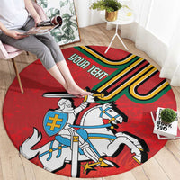 Red round carpet featuring a mounted knight and colorful coat-of-arms shield