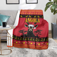 Red Angola blanket folded on floor with antelope portrait, gold lettering, and star border