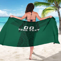 Green sarong back view with aztec pattern band and '00 YOUR TEXT' print