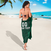 Green sarong with vertical aztec-print panel and '00 YOUR TEXT' on back