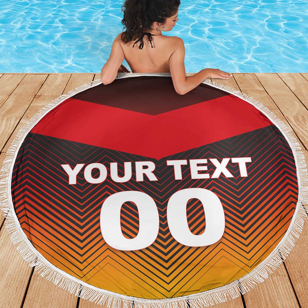 Round beach blanket with white fringe, “YOUR TEXT 00” over red black orange chevron