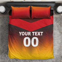 Red, yellow, and black bedding set with red pillows and chevron design, "YOUR TEXT 00".
