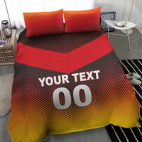 Red and yellow chevron bedding set with "YOUR TEXT 00" on duvet and two red pillows.