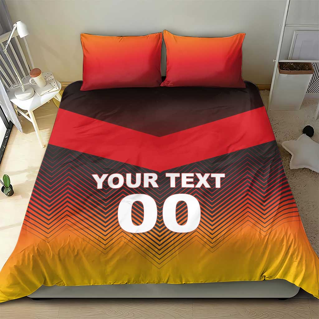 Bedding set on bed with two red pillows; dark chevron duvet reads "YOUR TEXT 00".