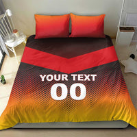 Bedding set on bed with two red pillows; dark chevron duvet reads "YOUR TEXT 00".