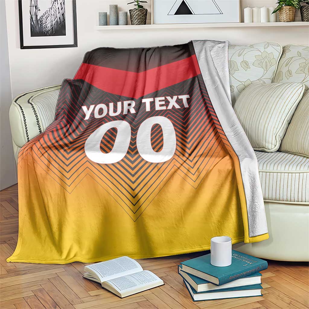 Germany football blanket draped on sofa, red, black, gold chevron with YOUR TEXT 00
