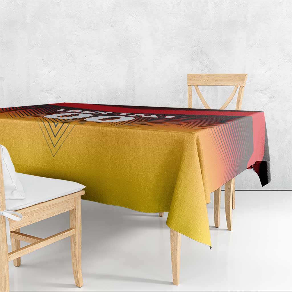 Red and gold football tablecloth draped on a table, with patterned flag style design
