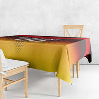 Red and gold football tablecloth draped on a table, with patterned flag style design