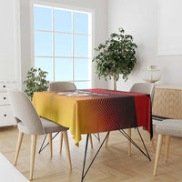 Red and gold football tablecloth on a dining table with patterned flag stripes